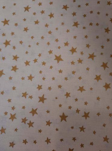 Tela Navidad estrella GRANDE dorada fondo beige. Ancho de tela 1,40mts.