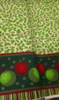 Tela Mantel Navidad Muerdago en fondo beige. Ancho de tela 1,40mts. Con greca.
