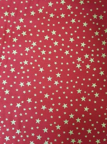 Tela Navidad estrella dorada fondo rojo. Ancho de tela 1,40mts.